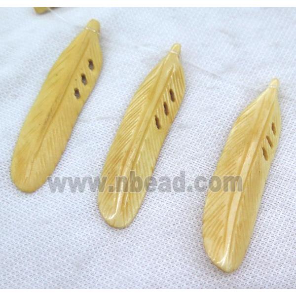 bone pendant, feather, yellow